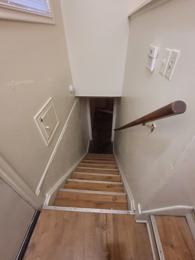 stairs with hardwood / wood-style flooring