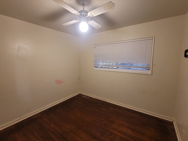 spare room with ceiling fan and dark hardwood / wood-style flooring