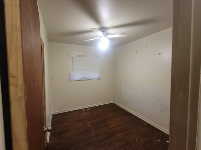 spare room featuring dark hardwood / wood-style floors and ceiling fan