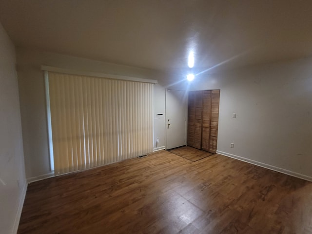 empty room with hardwood / wood-style floors