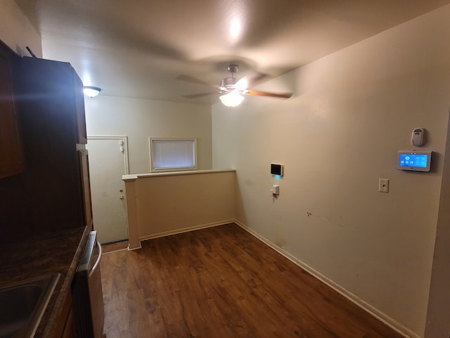 clothes washing area with dark hardwood / wood-style flooring, ceiling fan, and sink