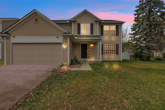 view of front of property with a yard and a garage