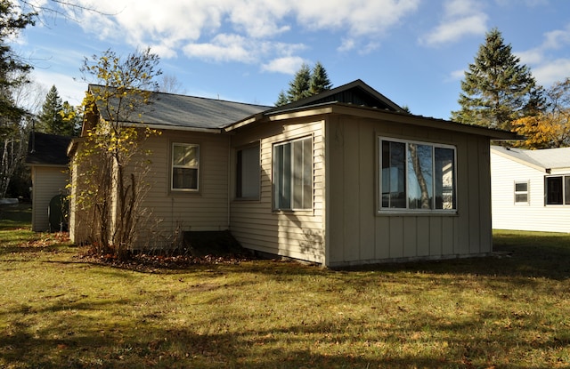 view of side of property with a yard