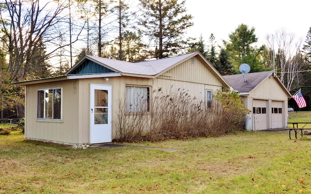 view of outbuilding with a lawn and a garage