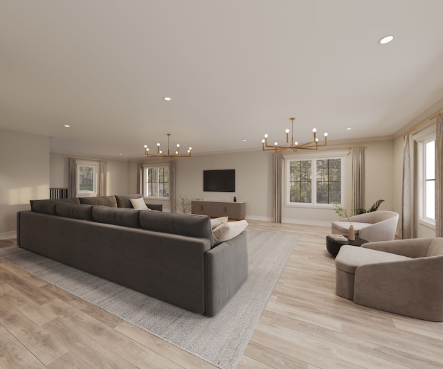 living room with an inviting chandelier, ornamental molding, and light wood-type flooring