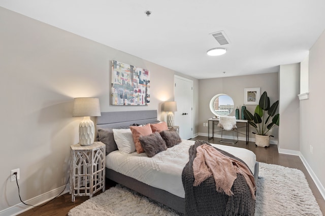 bedroom with dark wood-type flooring