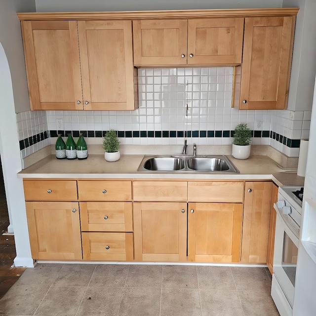 1453 S Merriman Rd, Westland, MI 48186 - kitchen with white electric stove, light tile patterned flooring, sink, and tasteful backsplash