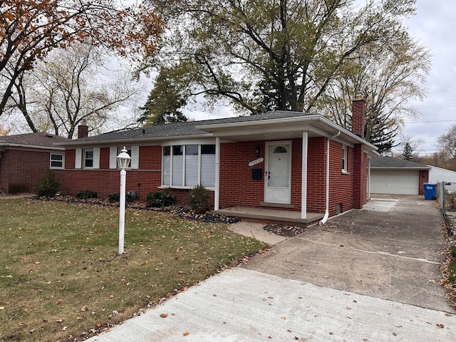 view of front facade with a front lawn, an outdoor structure, and a garage