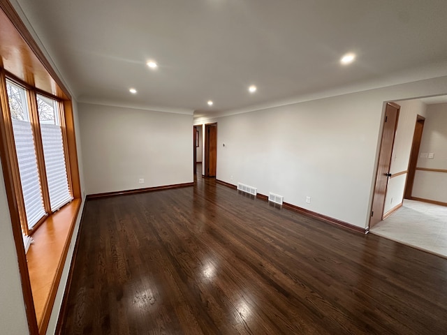 unfurnished room featuring dark hardwood / wood-style flooring and ornamental molding