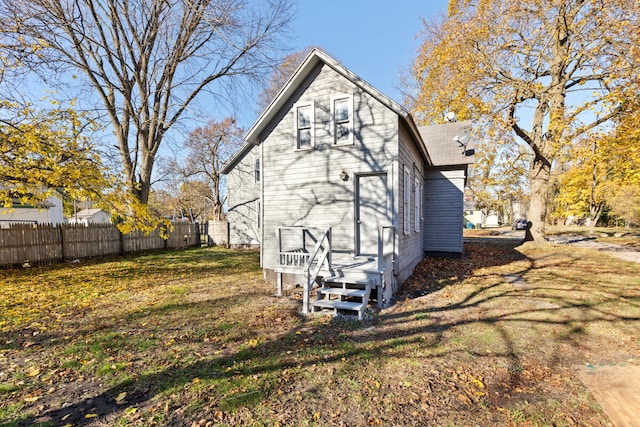 rear view of property with a lawn