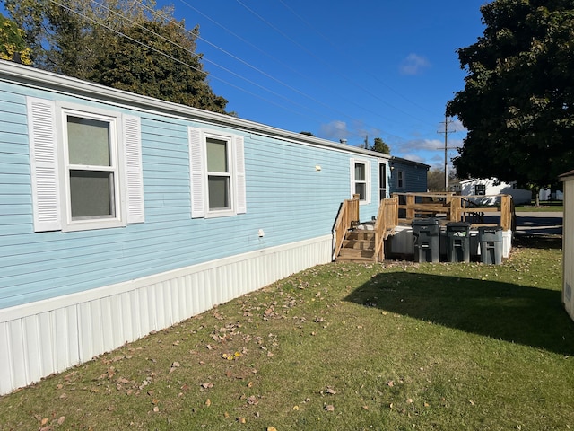 view of property exterior featuring a lawn and a deck