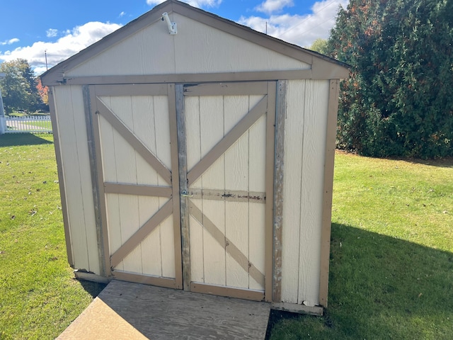 view of outbuilding featuring a lawn