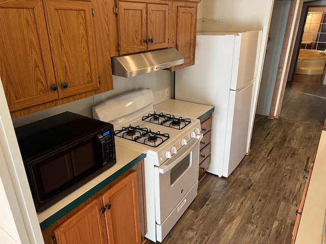 kitchen featuring white gas range and dark hardwood / wood-style flooring