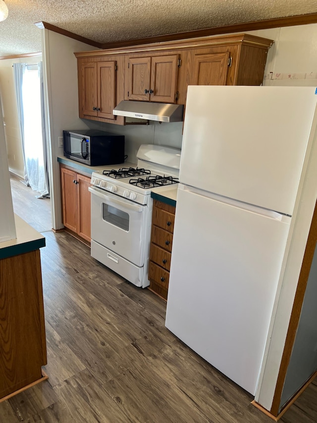 kitchen featuring white appliances, a textured ceiling, and dark wood-type flooring