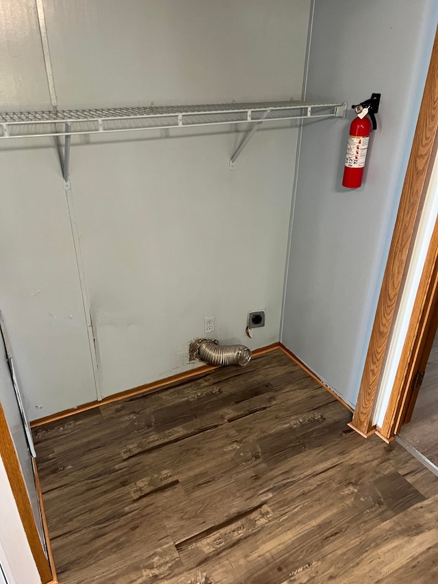 washroom featuring dark wood-type flooring and electric dryer hookup