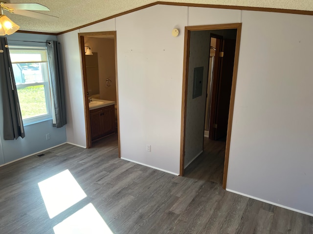 unfurnished room with crown molding, vaulted ceiling, dark hardwood / wood-style floors, ceiling fan, and a textured ceiling