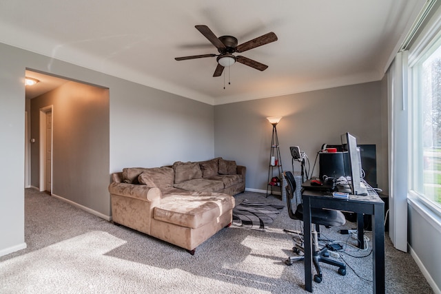 office area featuring carpet flooring, ceiling fan, and a healthy amount of sunlight