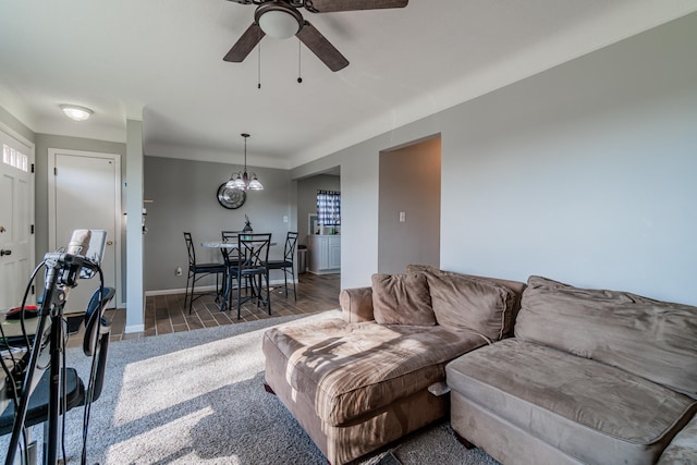 living room with dark hardwood / wood-style floors and ceiling fan with notable chandelier