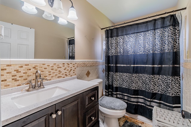 bathroom with curtained shower, vanity, tile walls, and toilet