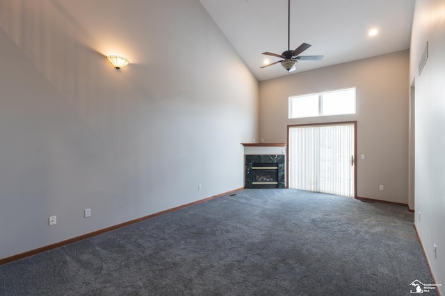 unfurnished living room with high vaulted ceiling, ceiling fan, a fireplace, and carpet flooring