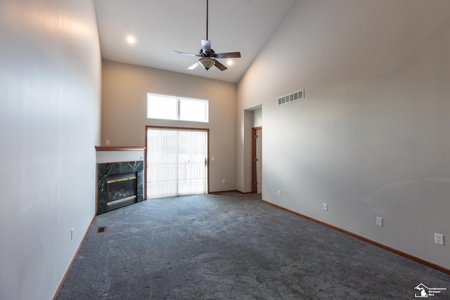 unfurnished living room featuring high vaulted ceiling, a fireplace, ceiling fan, and carpet flooring