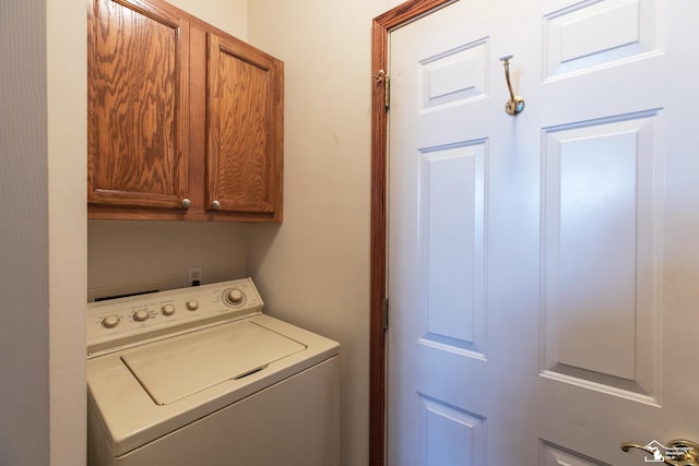 washroom featuring cabinets and washer / clothes dryer