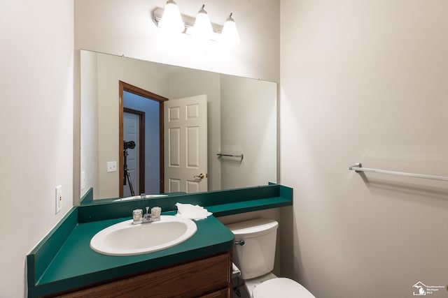 bathroom featuring toilet and vanity