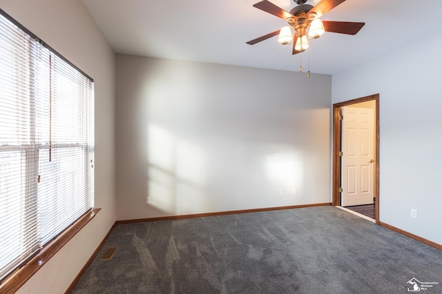 carpeted empty room featuring ceiling fan