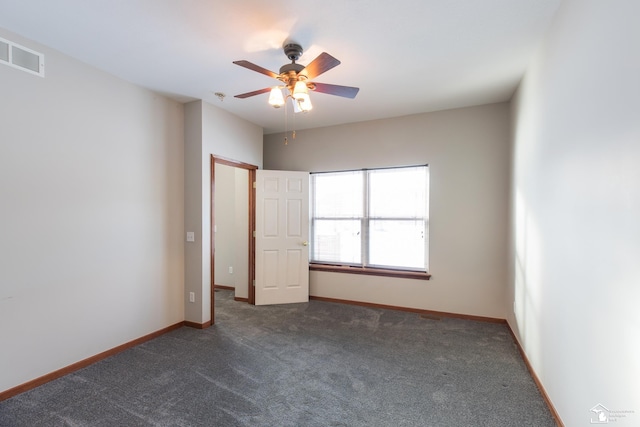 unfurnished bedroom featuring ceiling fan and dark colored carpet