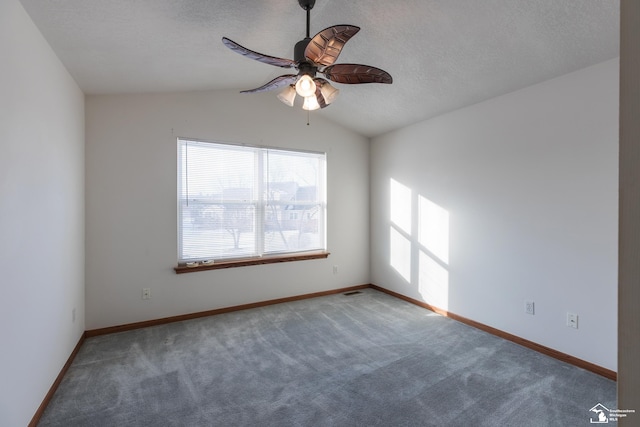 carpeted empty room with ceiling fan and lofted ceiling