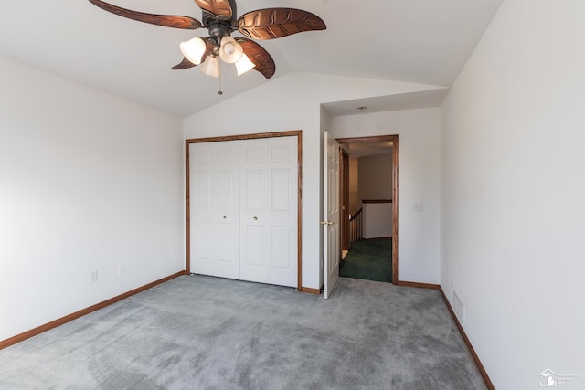 unfurnished bedroom featuring ceiling fan, carpet, a closet, and vaulted ceiling