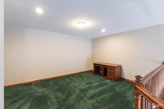 unfurnished room featuring dark colored carpet