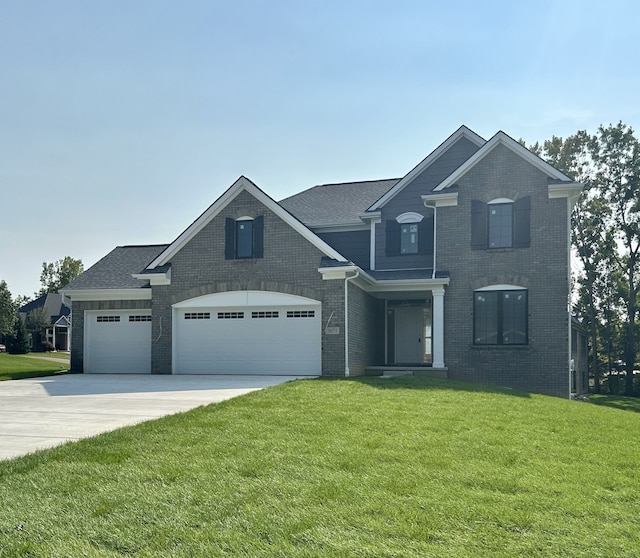 view of front of house with a front lawn, roof with shingles, concrete driveway, a garage, and brick siding