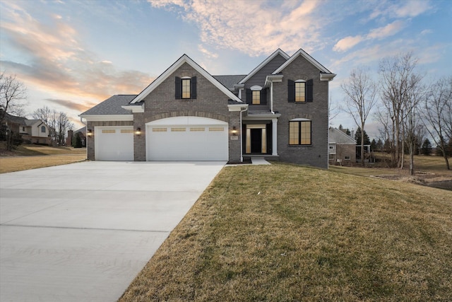 traditional-style home with brick siding, a lawn, concrete driveway, and a garage