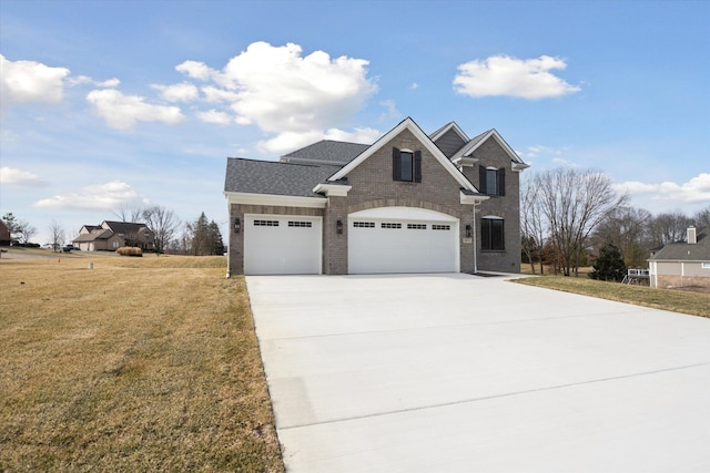 view of front of home with brick siding, an attached garage, a shingled roof, a front yard, and driveway