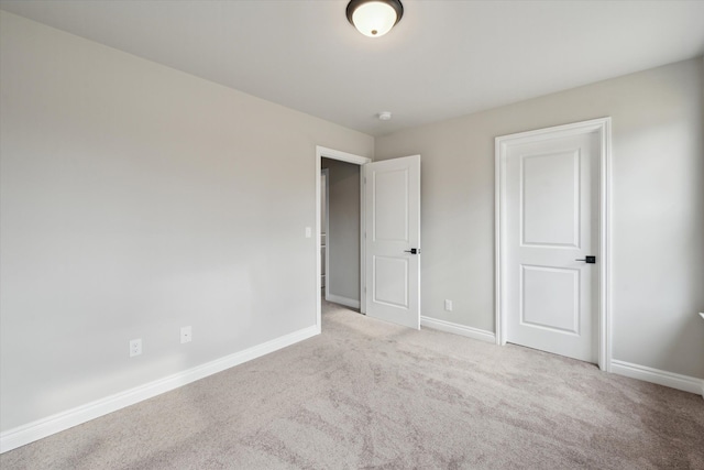 unfurnished bedroom with baseboards and carpet floors