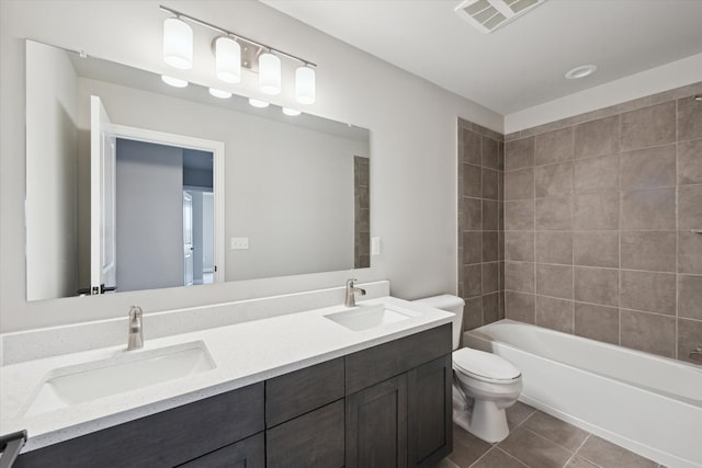 bathroom featuring a sink, visible vents, toilet, and tile patterned floors