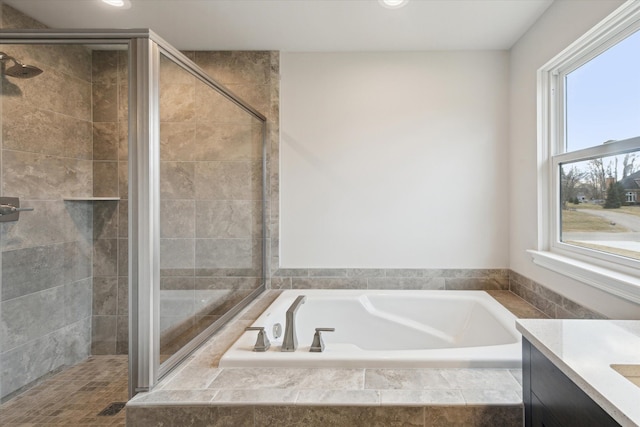 bathroom featuring recessed lighting, vanity, a bath, and a shower stall