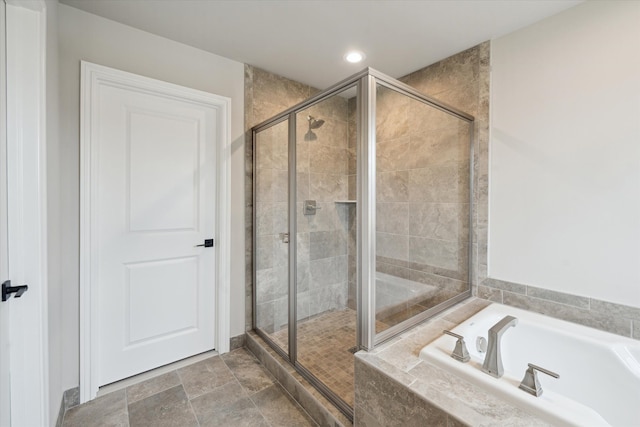 full bathroom featuring a garden tub, recessed lighting, a stall shower, and stone finish flooring