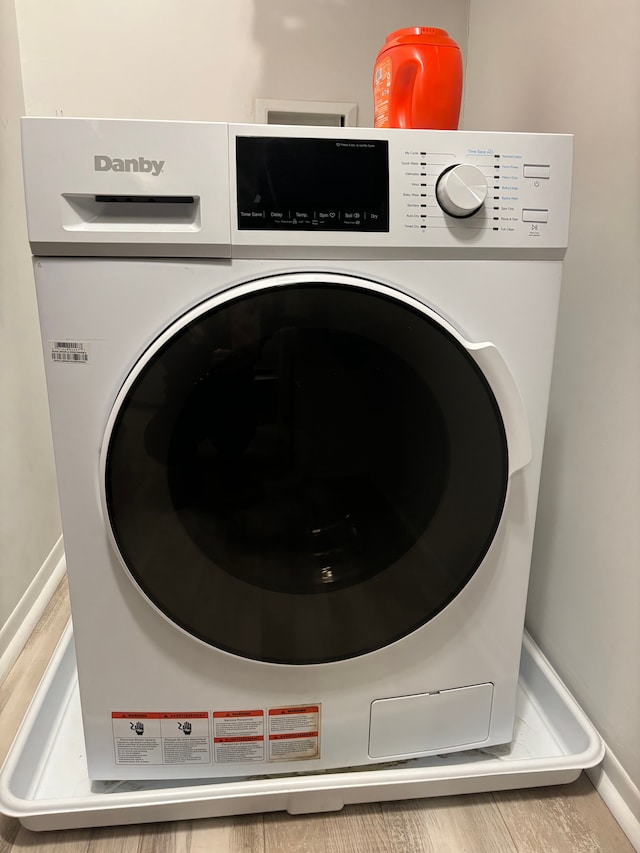 clothes washing area featuring washer / dryer