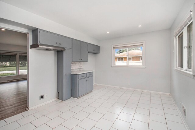 2955 Burlington Dr, Saginaw, MI 48601 - kitchen with gray cabinets, light countertops, baseboards, and recessed lighting