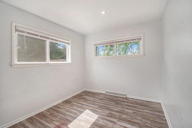 2955 Burlington Dr, Saginaw, MI 48601 - spare room featuring wood finished floors, baseboards, and recessed lighting