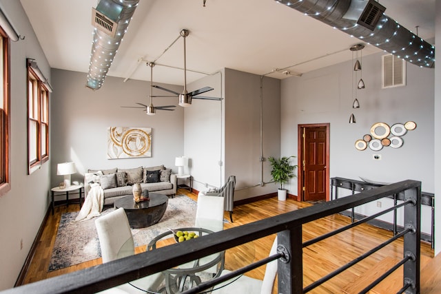 living room with hardwood / wood-style flooring and ceiling fan