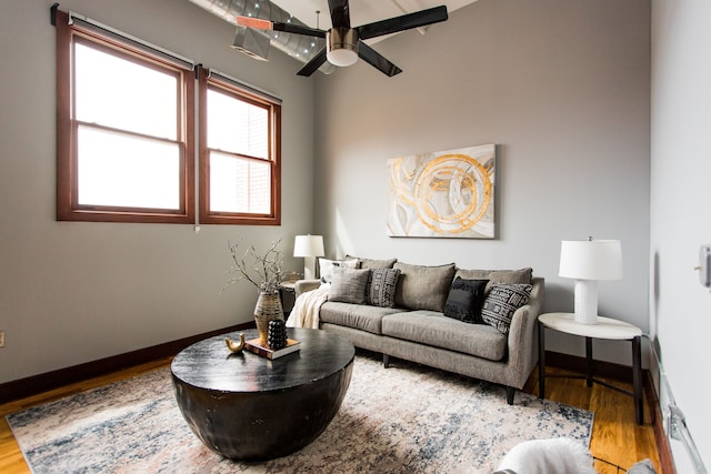 living room featuring ceiling fan and hardwood / wood-style floors