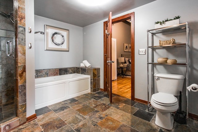 bathroom with toilet and separate shower and tub