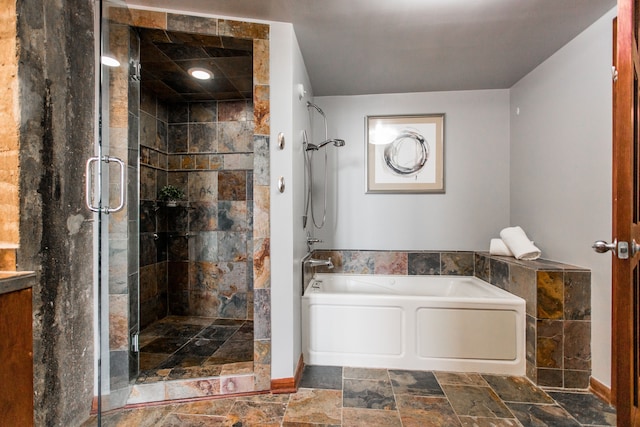 bathroom featuring independent shower and bath