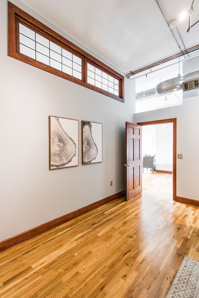 empty room with radiator and light hardwood / wood-style flooring