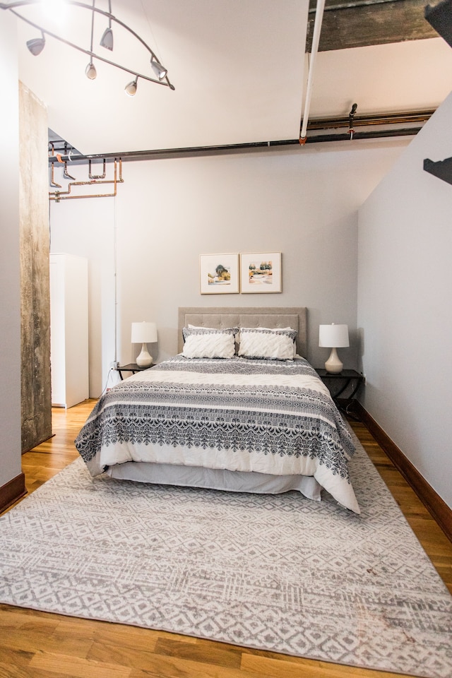 bedroom with hardwood / wood-style floors