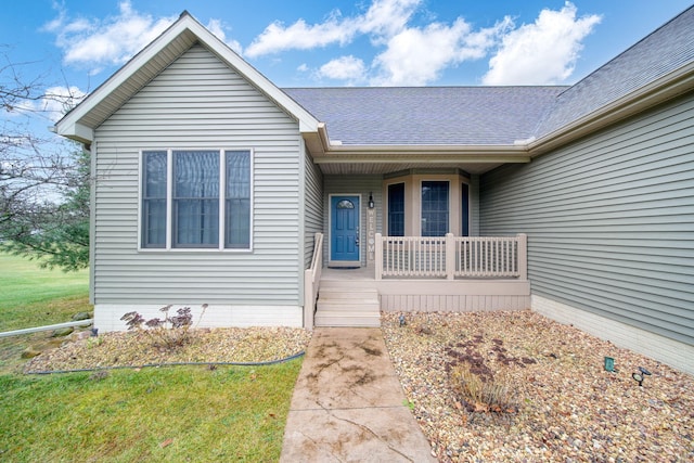 property entrance featuring a porch and a yard