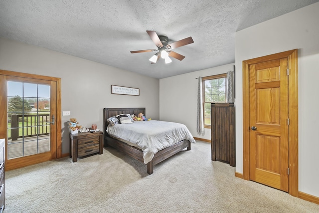 bedroom featuring carpet, ceiling fan, access to exterior, and a textured ceiling